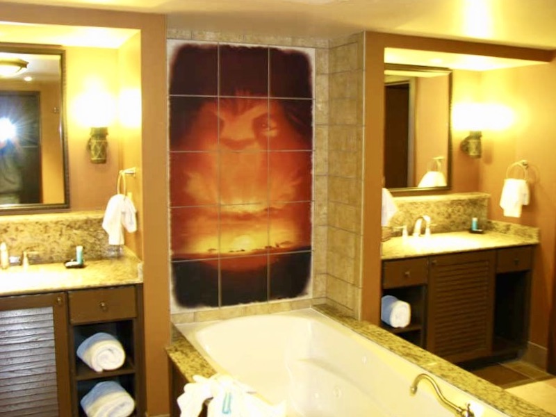 Master bathroom tub flanked by dual vanities