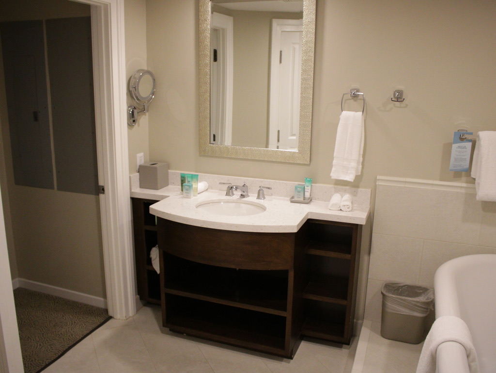 Master bathroom vanity, walk-in closet (right) and tub (left)