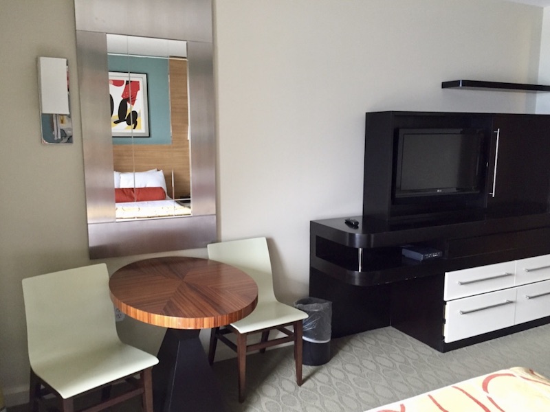 TV, armoire and side table with chairs