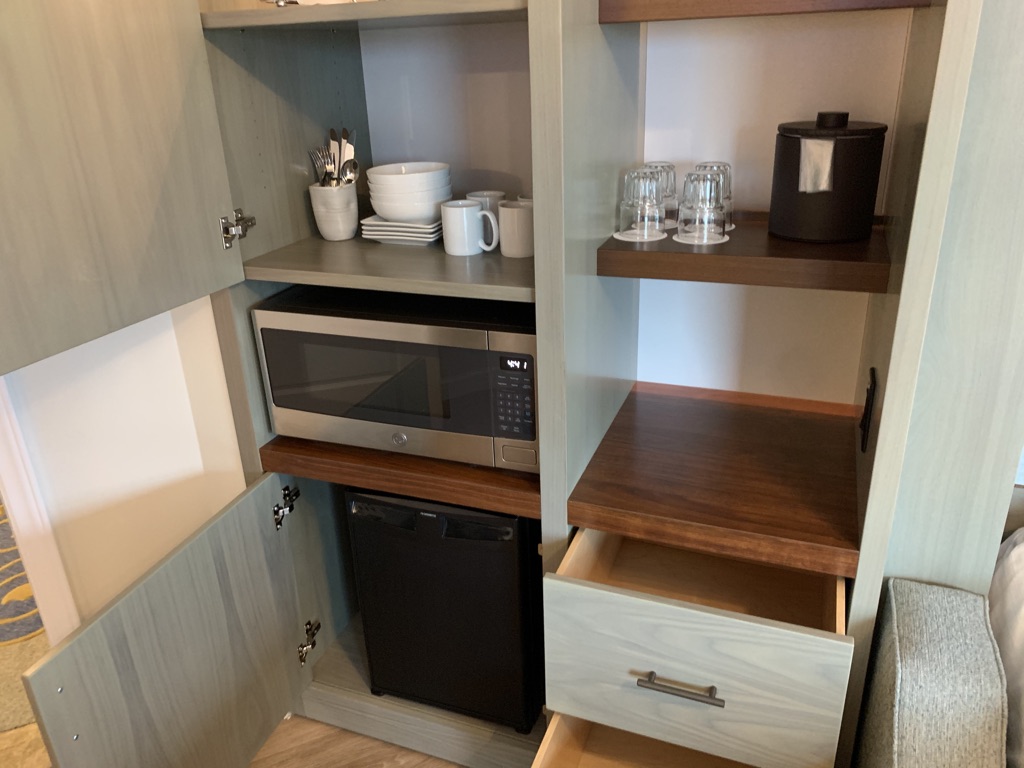 Left side storage panel with fridge, microwave and dishes
