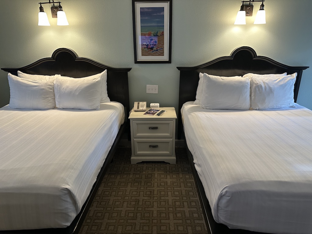 Two queen size beds with nightstand between