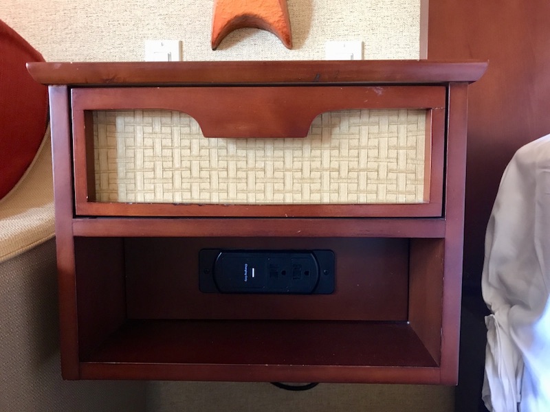 Nightstand with USB charging ports visible
